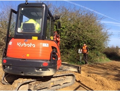 Digger smoothing the new path 