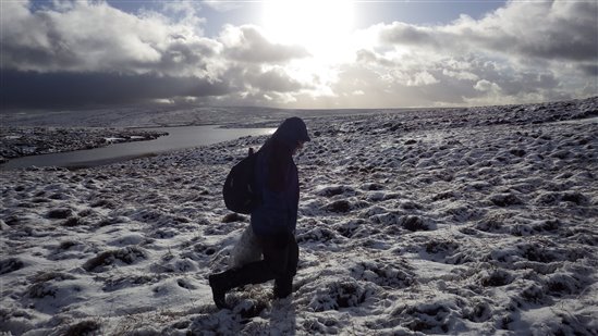 A volunteer in the snow at Dove Stone