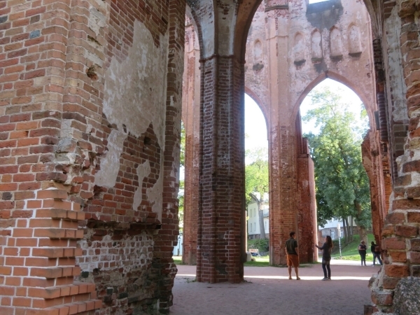 Brickwork inside Tartu Cathedral. Arches in the background give way to trees