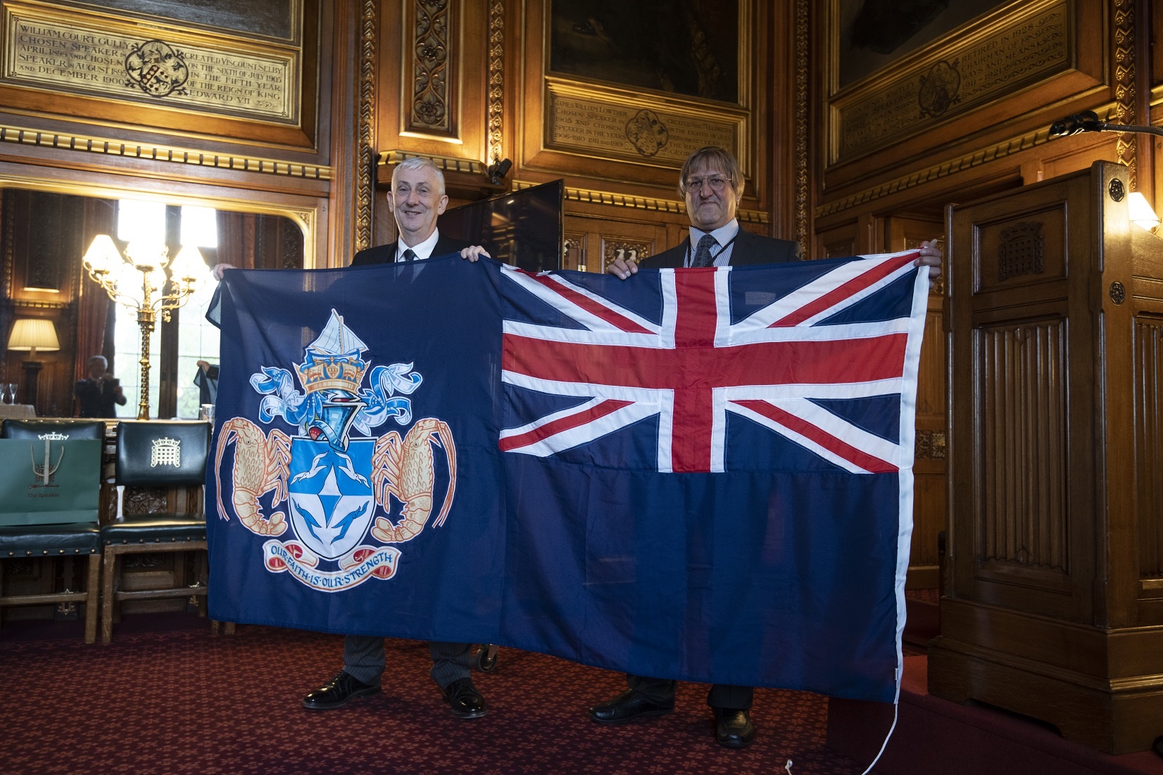 James Glass and Speaker holding up the Tristan flag