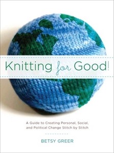 A 3D knitted planet earth has a banner across it with the words 'Knitting for good'.