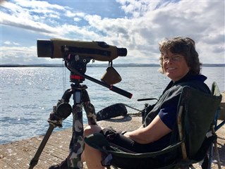 Hilary monitoring wildlife using a telescope on Coquet Island