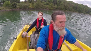 RSPB staff members in boat travelling to Blue Circle Island.