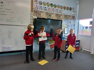 4 pupils giving a presentation in a classroom