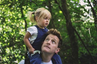  A father and daughter explore a nature