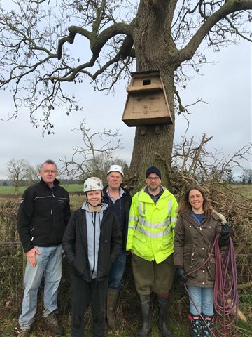 RSPB Worcester and Malvern Local Group Volunteers stand in front a recently installed Barn Owl Box