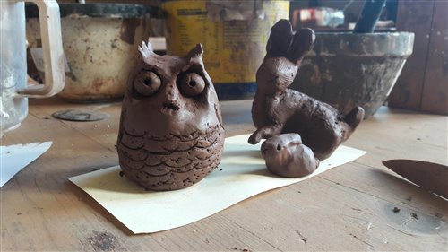 an clay owl and a clay rabbit