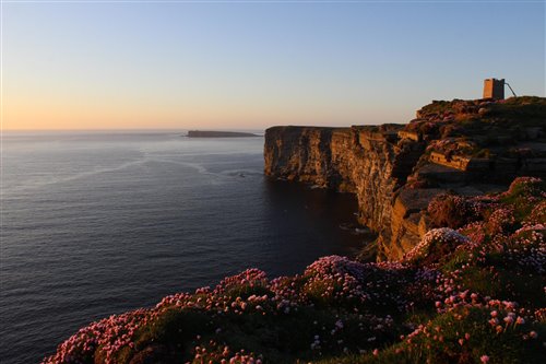 Cliffs by the sea lit in evening light