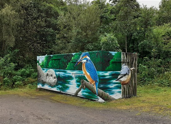 mural on cabin showing otter, kingfisher and nuthatch