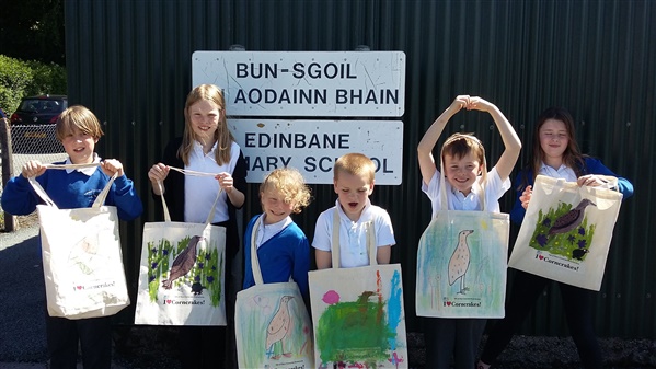 the kids show off their tote bag designs
