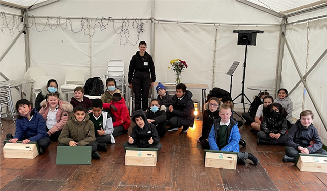 A group of primary school pupils showing off their swift boxes.