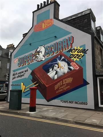 A mural painted on the wall of a house in Aberdeen depicts a gull as a boxed toy. It is titled "Super Scurry".