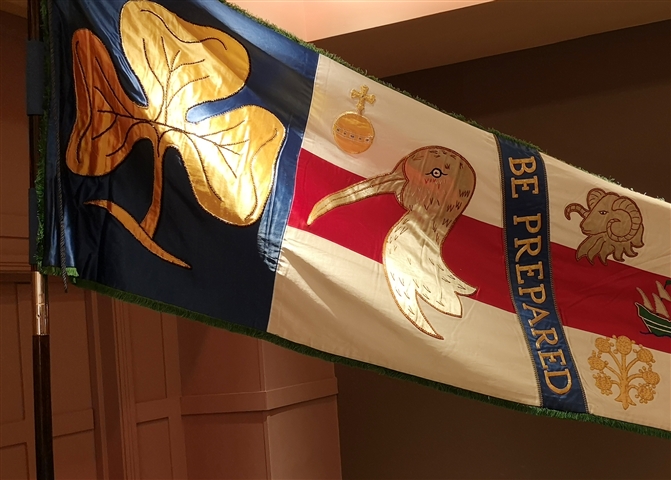 image shows a colourful banner made by the girl guides and a collage of a Curlew